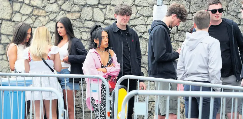  ?? AP ?? People arrive at Circus nightclub in Liverpool, England on Friday for a COVID-19 safety pilot event. Researcher­s at the event will gather evidence for the national Events Research programme which will see 6,000 clubbers across two nights take over Bramley Moore Dock warehouse in an event which requires no social distancing or face coverings.