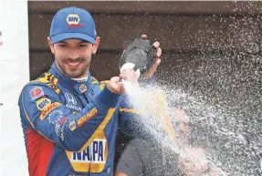  ?? MATTHEW O’HAREN/USA TODAY SPORTS ?? Alexander Rossi celebrates in victory lane after winning the ABC Supply 500 on Aug. 19 at Pocono Raceway.