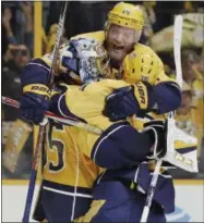  ?? MARK HUMPHREY — THE ASSOCIATED PRESS ?? Nashville Predators defenseman Mattias Ekholm (14), of Sweden, jumps on goalie Pekka Rinne (35), of Finland, and left wing Viktor Arvidsson (38), of Sweden, after the Predators beat the Anaheim Ducks to win Game 6 of the Western Conference final in the...