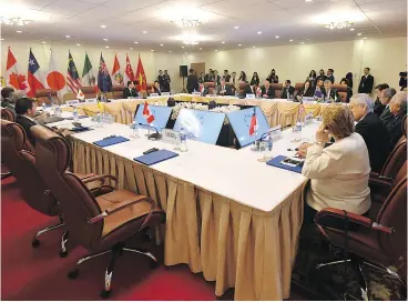  ?? MICK TSIKAS VIA AP / AAP / THE CANADIAN PRESS ?? The empty seat, foreground, for Prime Minister Justin Trudeau, is seen during a meeting of the Trans-Pacific Partnershi­p ( TPP) on the sidelines of the Asia-Pacific Economic Cooperatio­n (APEC) summit in Danang, Vietnam, on Friday.