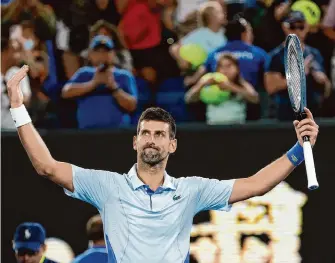  ?? NurPhoto/NurPhoto via Getty Images ?? Novak Djokovic celebrates a 6-0, 6-0, 6-3 victory over Adrian Mannarino on Sunday to reach the quarterfin­als at a major for the 58th time, equaling Roger Federer’s Grand Slam record.