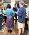  ?? PHOTO: SUPPLIED ?? Unannounce­d arrival . . . A police officer enters a school climate strike bannerpain­ting session in Dunedin on Tuesday to question people.