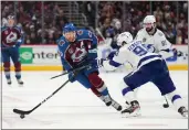  ?? JACK DEMPSEY — THE ASSOCIATED PRESS ?? Colorado Avalanche center Nathan MacKinnon (29) moves the puck against Tampa Bay Lightning defenseman Mikhail Sergachev (98) during the second period in Game 5of the Stanley Cup Final on Friday in Denver.