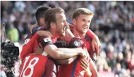  ?? AP ?? England’s Harry Kane (centre left) celebrates with teammates after scoring his side’s second goal during the World Cup Group F qualifying match against hosts Scotland yesterday.