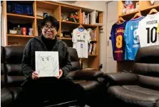  ?? AFP ?? This photo shows Japanese cartoonist and manga artist Yoichi Takahashi, best known for his work “Captain Tsubasa”, displaying his autograph with the painting of the main character following an interview with AFP at his workplace in Tokyo.—