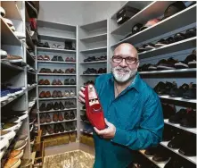  ??  ?? Clifton holds a favorite, a Donald Pliner shoe. He had his closet made extra large to accommodat­e his 145 pairs.