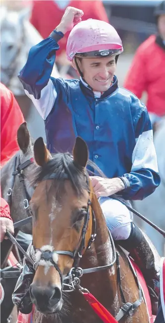  ??  ?? Corey Brown punches the air after winning the 157th Melbourne Cup on Rekindling at Flemington Racecourse in Melbourne yesterday.