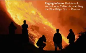  ??  ?? Raging inferno: Residents in Yorba Linda, California, watching the Blue Ridge Fire.