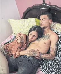  ??  ?? LEFT
Maria Ferreira, 23, and her husband, Joseph Cordova, 25, at their home. The couple plan their sex life on how many condoms they can afford each month.