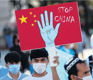  ?? PHOTO: REUTERS ?? Ethnic Uighur demonstrat­ors take part in a protest against China, in Turkey.