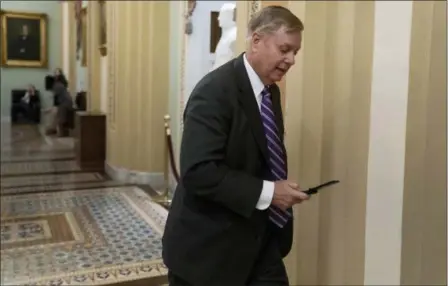  ?? J. SCOTT APPLEWHITE — THE ASSOCIATED PRESS ?? Sen. Lindsey Graham, R-S.C., a member of the Senate Armed Services Committee, rushes to the office of Senate Majority Leader Mitch McConnell, R-Ky., at day’s end Wednesday on Capitol Hill in Washington. Amid the news that President Donald Trump is pulling all 2,000 U.S. troops out of Syria, Graham said he was “blindsided” by the report and called the decision “a disaster in the making.”