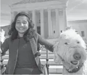  ?? MOLLY RILEY, AP ?? Ehlena Fry of Michigan sits with her service dog Wonder outside the Supreme Court in October.