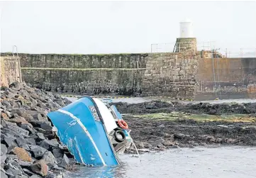  ??  ?? The wrecked fishing boat on rocks at Pittenweem Harbour. Picture by Gareth Jennings.