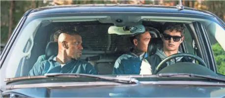  ?? PHOTOS BY WILSON WEBB ?? Bats (Jamie Foxx), JD (Lanny Joon) and Baby (Ansel Elgort) go through several rides after an armored car heist in Baby Driver.