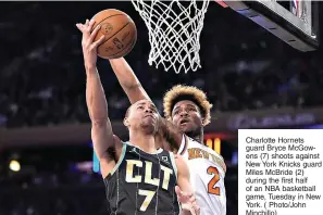  ?? ?? Charlotte Hornets guard Bryce McGowens (7) shoots against New York Knicks guard Miles McBride (2) during the first half of an NBA basketball game, Tuesday in New York. ( Photo/John Minchillo)