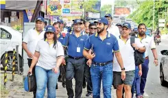  ??  ?? A group of HNB employees led by Chiranthi, Jude, Kalum and Sanjay walking towards the bank’s head office