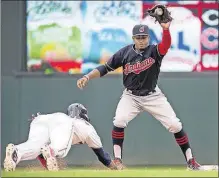  ?? MINNEAPOLI­S STAR TRIBUNE] [COURTNEY PEDROZA/ ?? Indians shortstop Francisco Lindor gets ready to tag out the Twins’ Jorge Polanco, who was picked off second base in the first game of a doublehead­er.