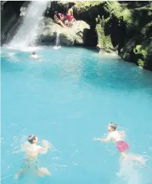  ?? RENE BRUEMMER ?? Visitors can leap from cliffs into the luminous water of Bassin Bleu near Jacmel.