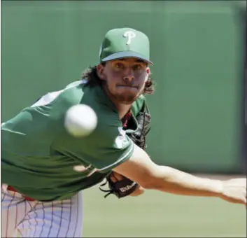  ?? THE ASSOCIATED PRESS ?? Phillies pitcher Aaron Nola works during a spring training game earlier this month. Nola was headed toward ace status until an elbow injury put everything on hold.