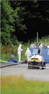  ??  ?? Forensic officers at the scene on the A4059, near Abercynon,