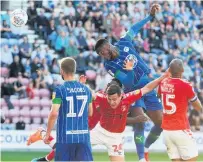  ??  ?? HEADS WE WIN Chey Dunkley rises above the Charlton defence