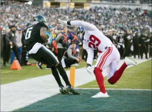  ?? RICH HUNDLEY III — 21ST-CENTURY MEDIA PHOTO ?? Eagles wide receiver DeVonta Smith, left, catches a touchdown pass as Giants defensive back Xavier McKinney, right, tries to shove him out of bounds during a NFL game at Lincoln Financial Field in Philadelph­ia on Sunday afternoon.