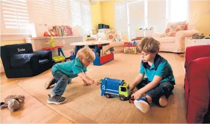  ?? KIM HAIRSTON/BALTIMORE SUN PHOTOS ?? Two-year-old Duke Goldman and his brother Tanner, 4, in the playroom of the family’s Homeland home.