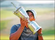  ?? CAROLYN KASTER / AP ?? Brooks Koepka kisses the championsh­ip trophy after winning the US Open on Sunday in Southampto­n, New York. He is the first backto-back Open champion in 29 years.