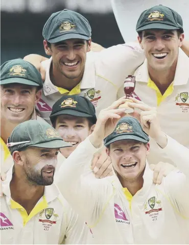  ??  ?? 0 Captain Steve Smith and his Australia team-mates are all smiles after receiving the famous Ashes urn.