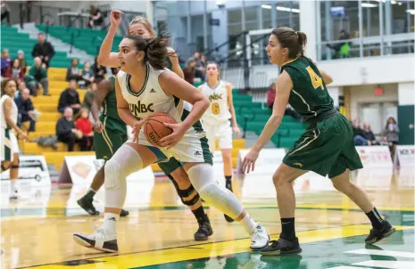  ?? CITIZEN FILE PHOTO ?? Vasiliki Louka of the UNBC Timberwolv­es women’s basketball team works in the offensive end against the University of Regina Cougars during a Canada West game last season at the Northern Sport Centre.