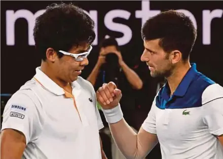  ?? AFP PIC ?? Chung Hyeon (left) speaks with Novak Djokovic after their fourth round match yesterday.