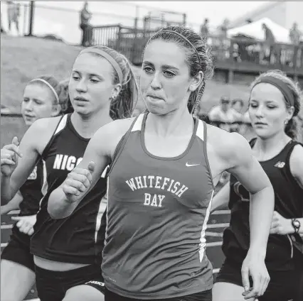  ??  ?? Cami Davre of Whitefish Bay wins the 1,600-meter run during the WIAA track and field sectional at Oconomowoc High School on Friday. Davre advanced to the state track meet in La Crosse next weekend, where she’ll try to beat a record set by Suzy Favor in...