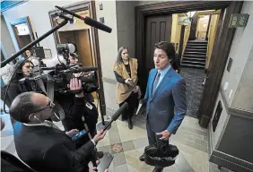  ?? SEAN KILPATRICK THE CANADIAN PRESS ?? Prime Minister Justin Trudeau talks to reporters in the foyer as he arrives for question period in the House of Commons on Parliament Hill in Ottawa on Monday.