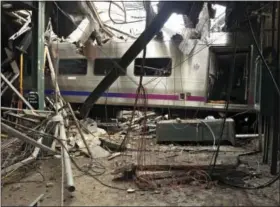  ?? CHRIS O’NEIL — NATIONAL TRANSPORTA­TION SAFETY BOARD VIA AP, FILE ?? FILE – This file photo provided by the National Transporta­tion Safety Board shows damage from a commuter train crash that killed a woman and injured more than 100 people at the Hoboken Terminal in Hoboken, N.J. More than 40 New Jersey Transit train...