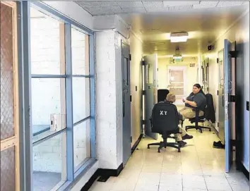  ?? Christina House
For The Times ?? DETENTION SERVICES officers watch over minors in the special handling unit at Central Juvenile Hall in Los Angeles. Those who oppose splitting the agency into two say it would be too costly and disruptive.