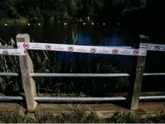  ?? (Getty) ?? Tape showing ‘no swimming’ symbols adorns the fence at Hampstead Heath’s bathing pond