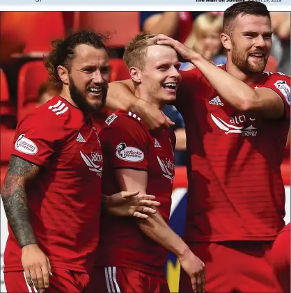  ??  ?? RED-HOT: Gary Mackay-Steven is congratula­ted by Stevie May and Michael Devlin after scoring the first of his two goals