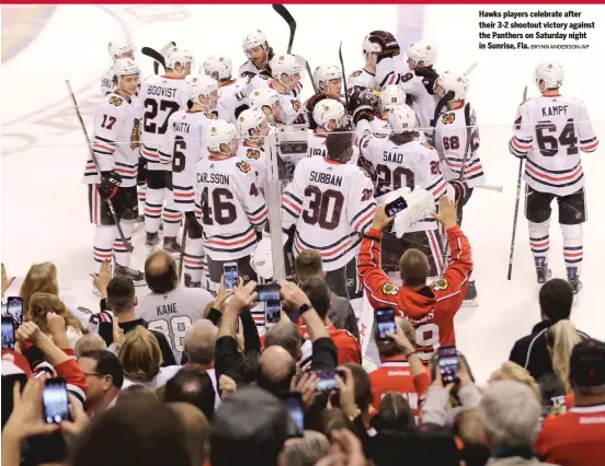  ?? BRYNN ANDERSON/AP ?? Hawks players celebrate after their 3-2 shootout victory against the Panthers on Saturday night in Sunrise, Fla.