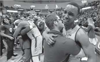  ??  ?? File, Mic Smith / AP
College of Charleston’s Joe Chealey (right) is overcome with emotions after beating Northeaste­rn in the Colonial Athletic Associatio­n tournament at the North Charleston Coliseum in North Charleston, S.C.