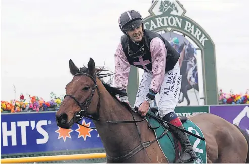  ?? Picture / Race Images ?? Hamish McNeill celebrates Ready Eddie’s victory in the Grand National Hurdles at Riccarton yesterday.