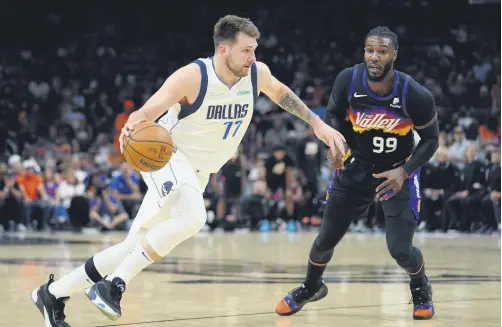 ?? ?? Mavericks Luka Doncic (L) drives the ball against Suns’ Jae Crowder (R) in an NBA playoff game, Phoenix, U.S., May 15, 2022.