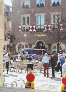  ??  ?? STUNNED: A crowd lingers outside the Kiepenkerl pub, site of yesterday’s van crash.