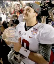  ?? AP/DAVID J. PHILLIP ?? Alabama quarterbac­k AJ McCarron holds The Coaches’ Trophy after the Crimson Tide won their second consecutiv­e BCS national championsh­ip with a 42-14 victory over Notre Dame on Monday.
