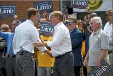  ?? Steve Mellon/Post-Gazette ?? Rep. Conor Lamb, left, is greeted by Allegheny County Executive Rich Fitzgerald shortly after Mr. Lamb announced his run for Pat Toomey’s Senate seat.