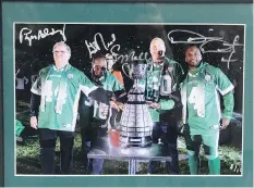  ?? TROY FLEECE ?? This signed, framed photo of Saskatchew­an Roughrider­s legends Roger Aldag, George Reed, Gene Makowsky and Darian Durant will be available at the Regina Leader-Post’s annual charity sports memorabili­a sale, to be held April 29 at Conexus Arts Centre.