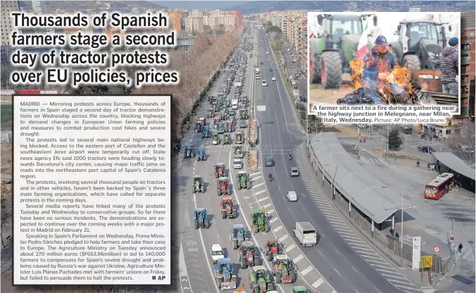  ?? ?? Farmers drive their tractors during a protest in Barcelona, Spain on Wednesday. Mirroring protests across Europe, thousands of farmers in Spain staged a second day of tractor protests Wednesday across the country, blocking highways to demand changes in European Union farming policies and measures to combat production cost rises and severe drought.
