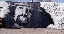  ?? ?? A large mural of rapper Keak da Sneak — one of the founders of the hyphy sound — is seen in Oakland in a scene from “We Were Hyphy.”