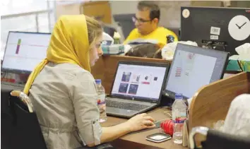  ?? — Reuters ?? Bamilo employees working at the e-commerce site's offices in the Iranian capital Tehran.