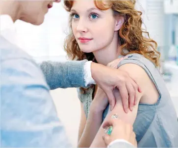  ??  ?? PROTECTION: A young woman having an HPV vaccinatio­n