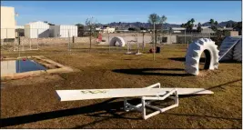  ?? Buy these photos at YumaSun.com PHOTOS BY BLAKE HERZOG/YUMA SUN ?? ABOVE: FORTUNA DOG PARK includes a variety of climbing and agility equipment for small and large dogs, plus a three-foot deep pool and a splash pad. RIGHT: Will, a 12-year-old Lab and retired service dog, was able to get on top of these tires at the...